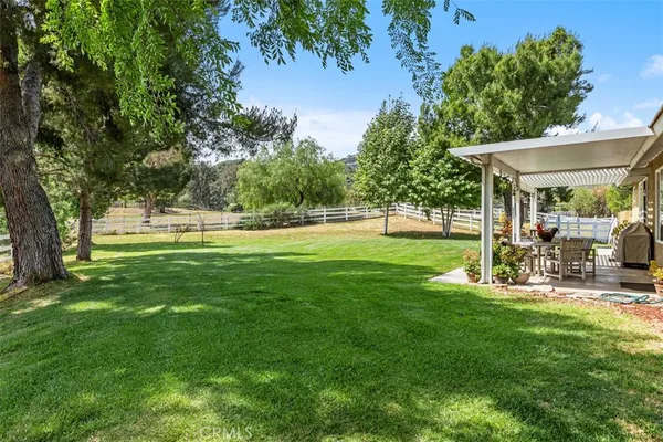 a view of a house with a backyard porch and sitting area