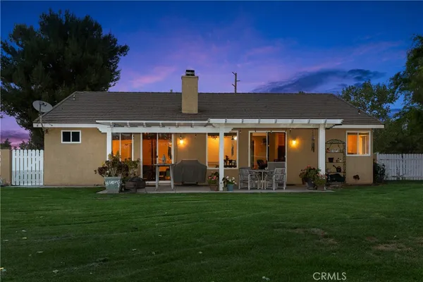 a front view of a house with a garden and yard
