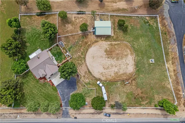 an aerial view of a house with garden space and street view