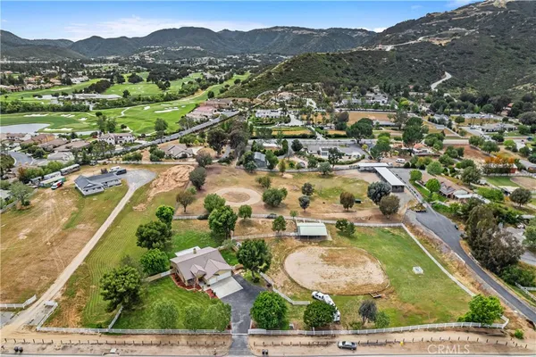 an aerial view of residential houses with outdoor space and street view