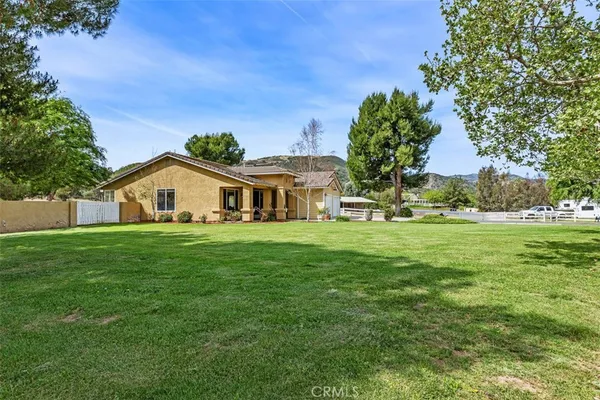 a front view of house with yard and green space