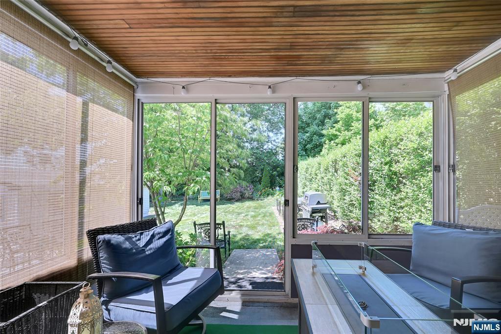 85 Edison Street Clifton, NJ 07013 - Photo 19 of 28 a view of a patio with table and chairs with wooden floor and wooden fence