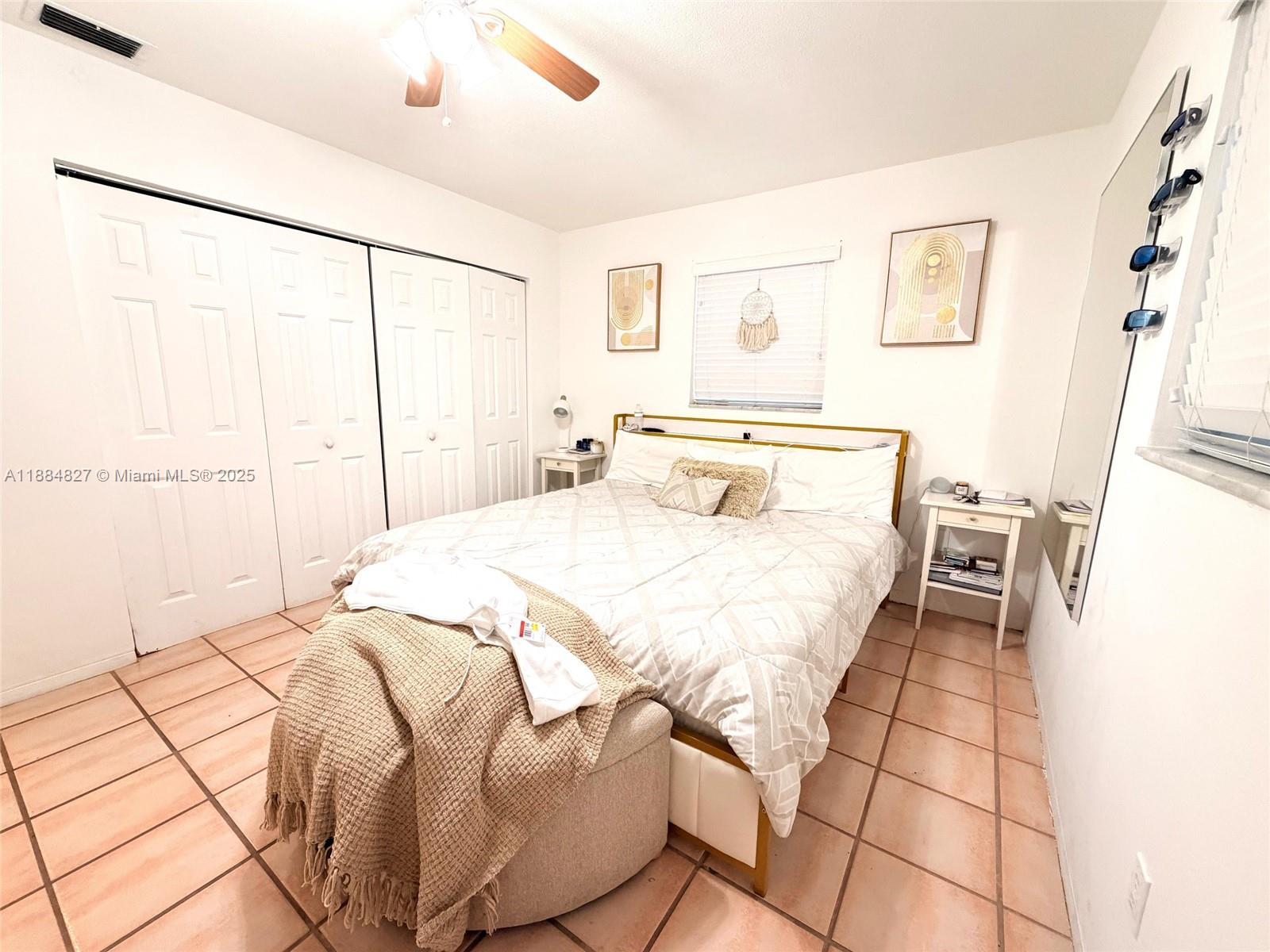 401 Southeast 5th Street Dania Beach, FL 33004 - Photo 6 of 9 a bedroom with a bed and a window