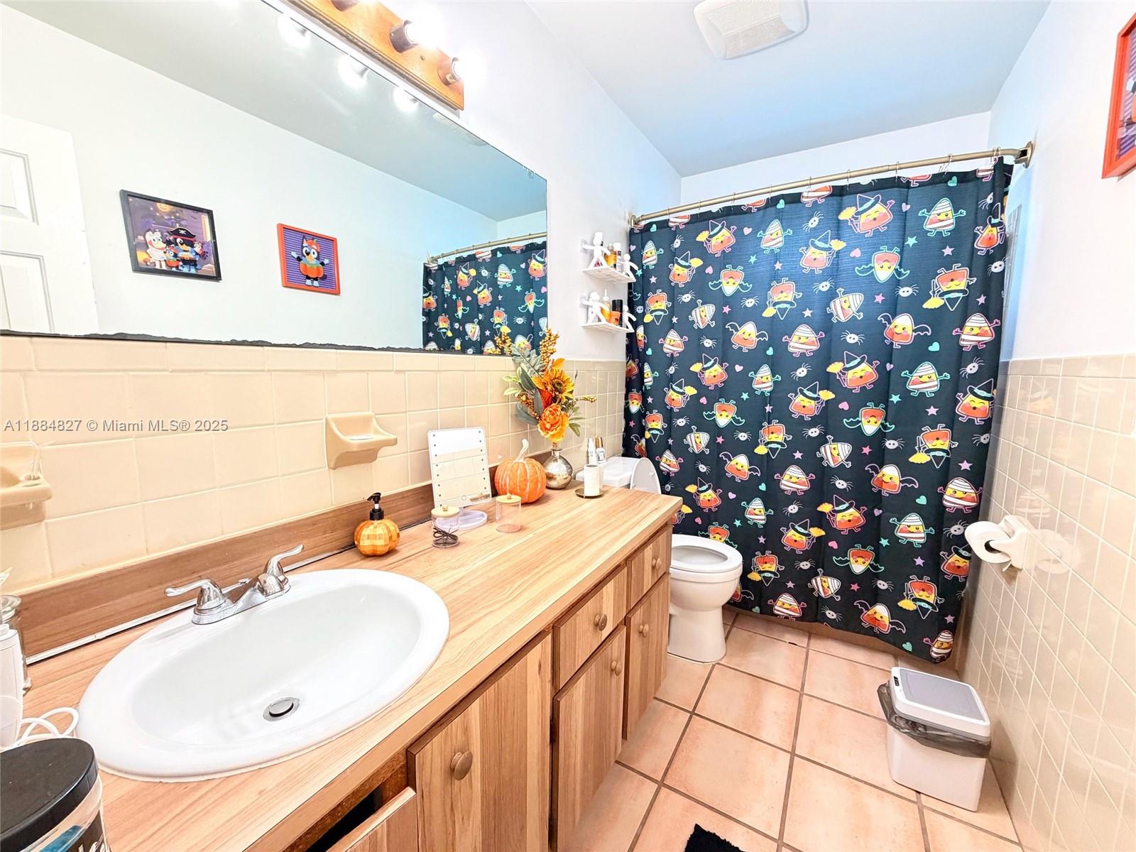 401 Southeast 5th Street Dania Beach, FL 33004 - Photo 7 of 9 a bathroom with a sink mirror and vanity