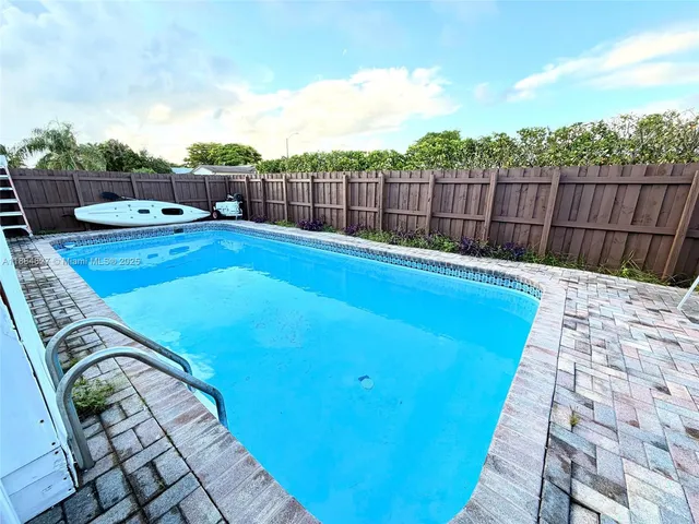 a swimming pool with wooden fence