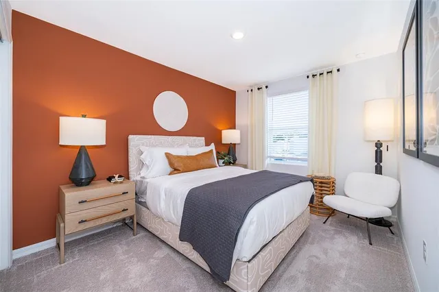 a bedroom with a bed and chair