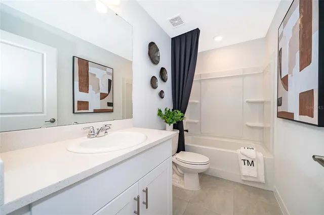 a bedroom with a bed table and a window