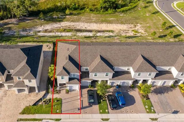 an aerial view of residential houses with outdoor space