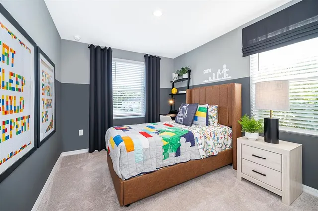 a bedroom that has a bed and a table in it