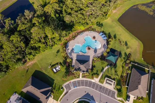 an aerial view of a house with a swimming pool