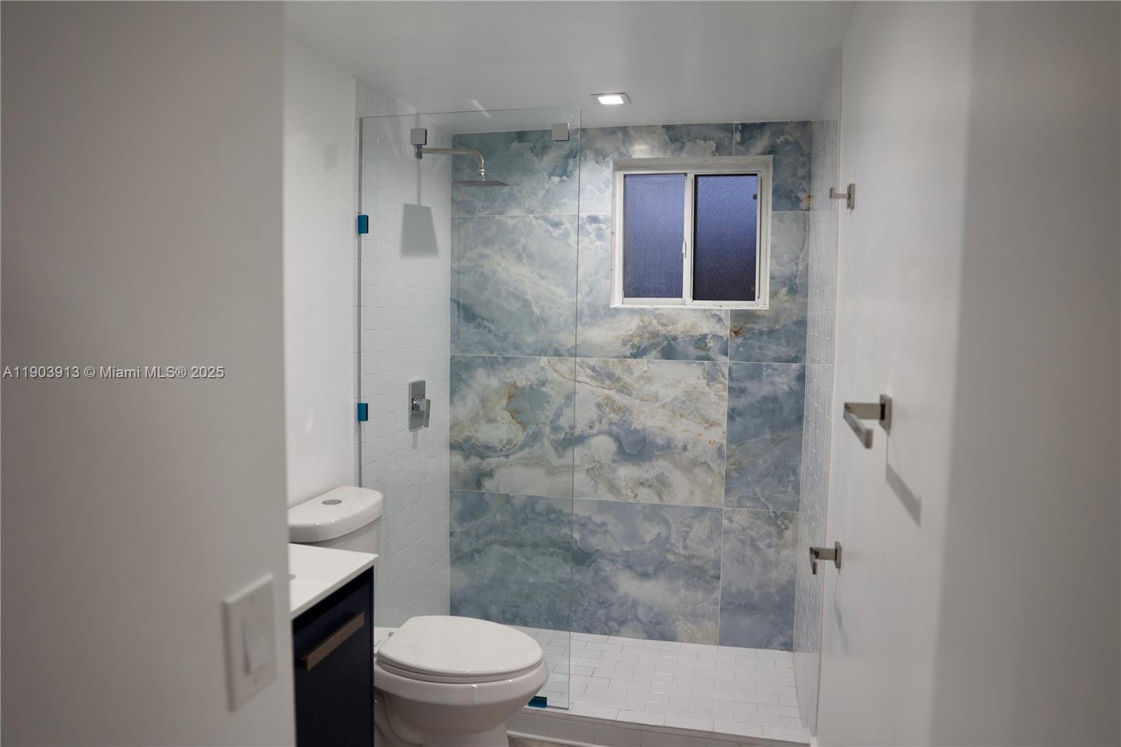 8730 Southwest 133rd Avenue Road, Unit 216 Miami, FL 33183 - Photo 15 of 28 a bathroom with a shower a toilet and a sink