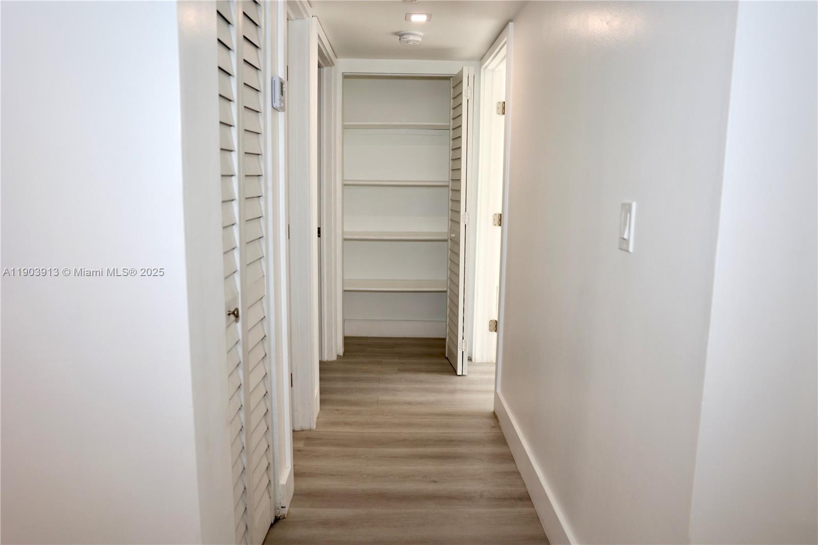 8730 Southwest 133rd Avenue Road, Unit 216 Miami, FL 33183 - Photo 20 of 28 a view of a hallway with wooden floor and closet