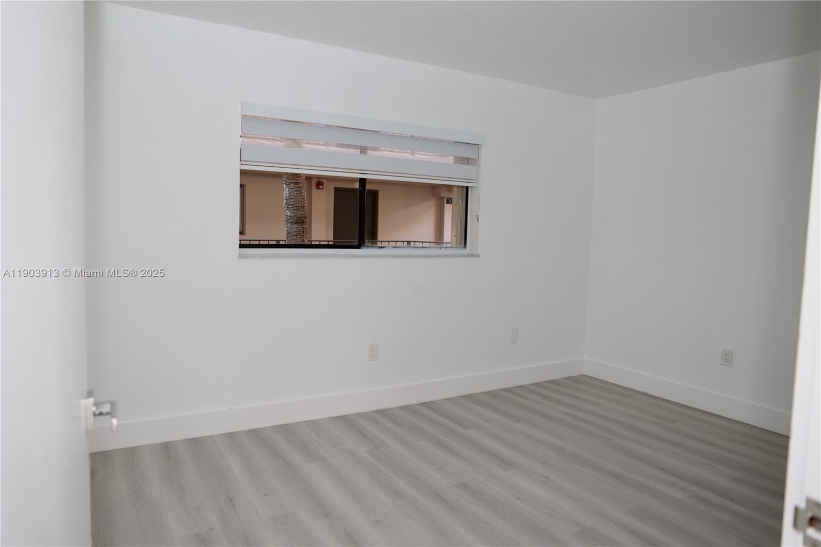 8730 Southwest 133rd Avenue Road, Unit 216 Miami, FL 33183 - Photo 21 of 28 wooden floor in an empty room