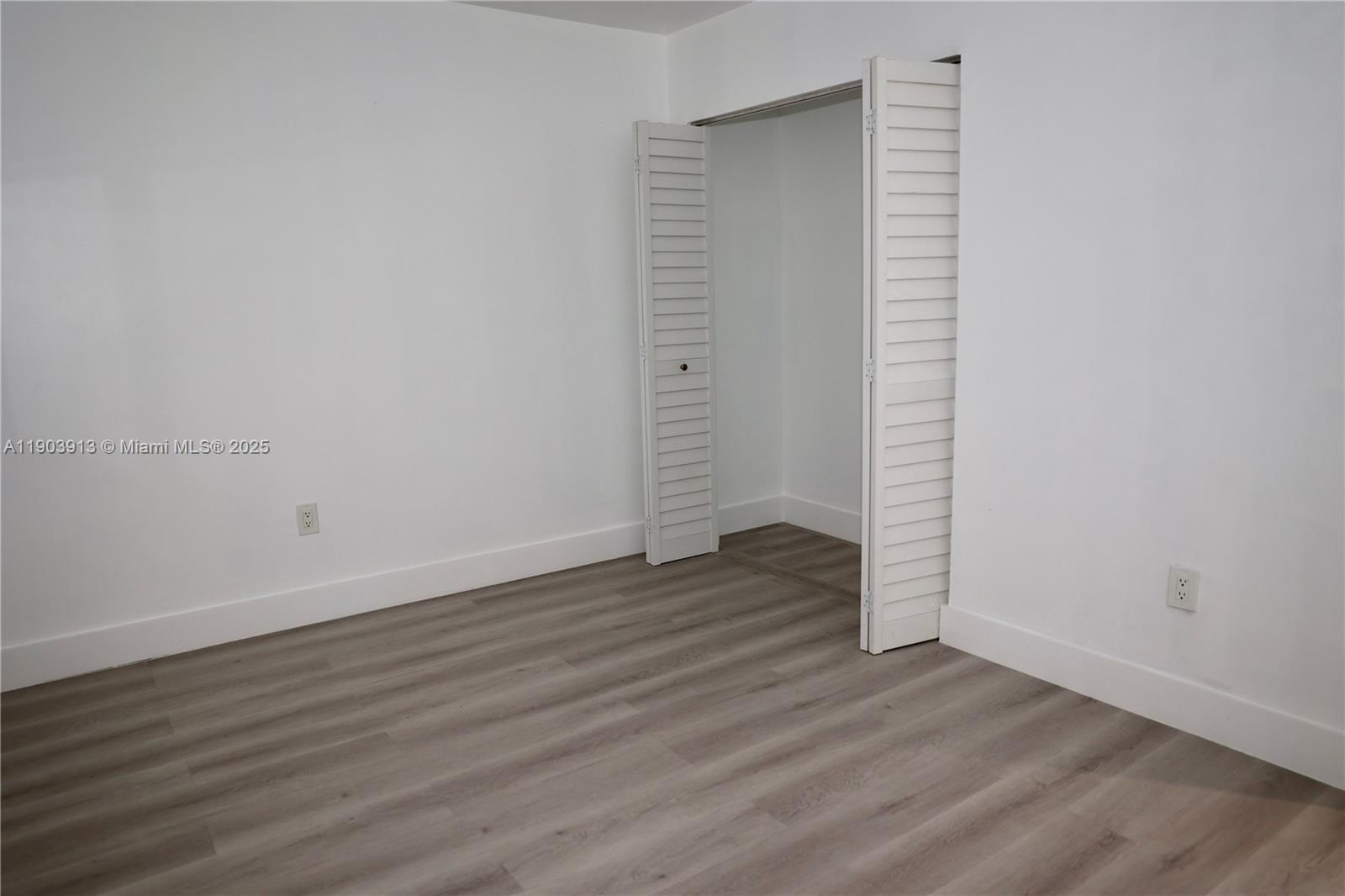 8730 Southwest 133rd Avenue Road, Unit 216 Miami, FL 33183 - Photo 22 of 28 an empty room with wooden floor