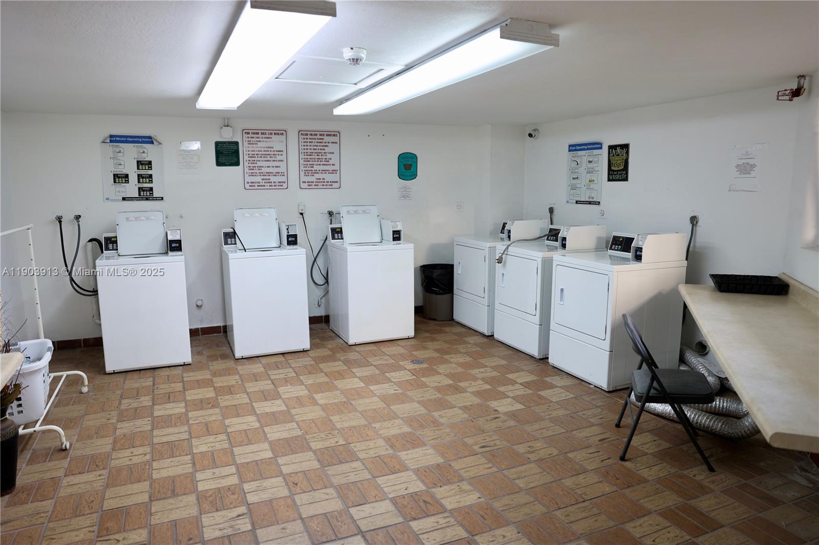 8730 Southwest 133rd Avenue Road, Unit 216 Miami, FL 33183 - Photo 25 of 28 a room with furniture a white stove a table and white walls