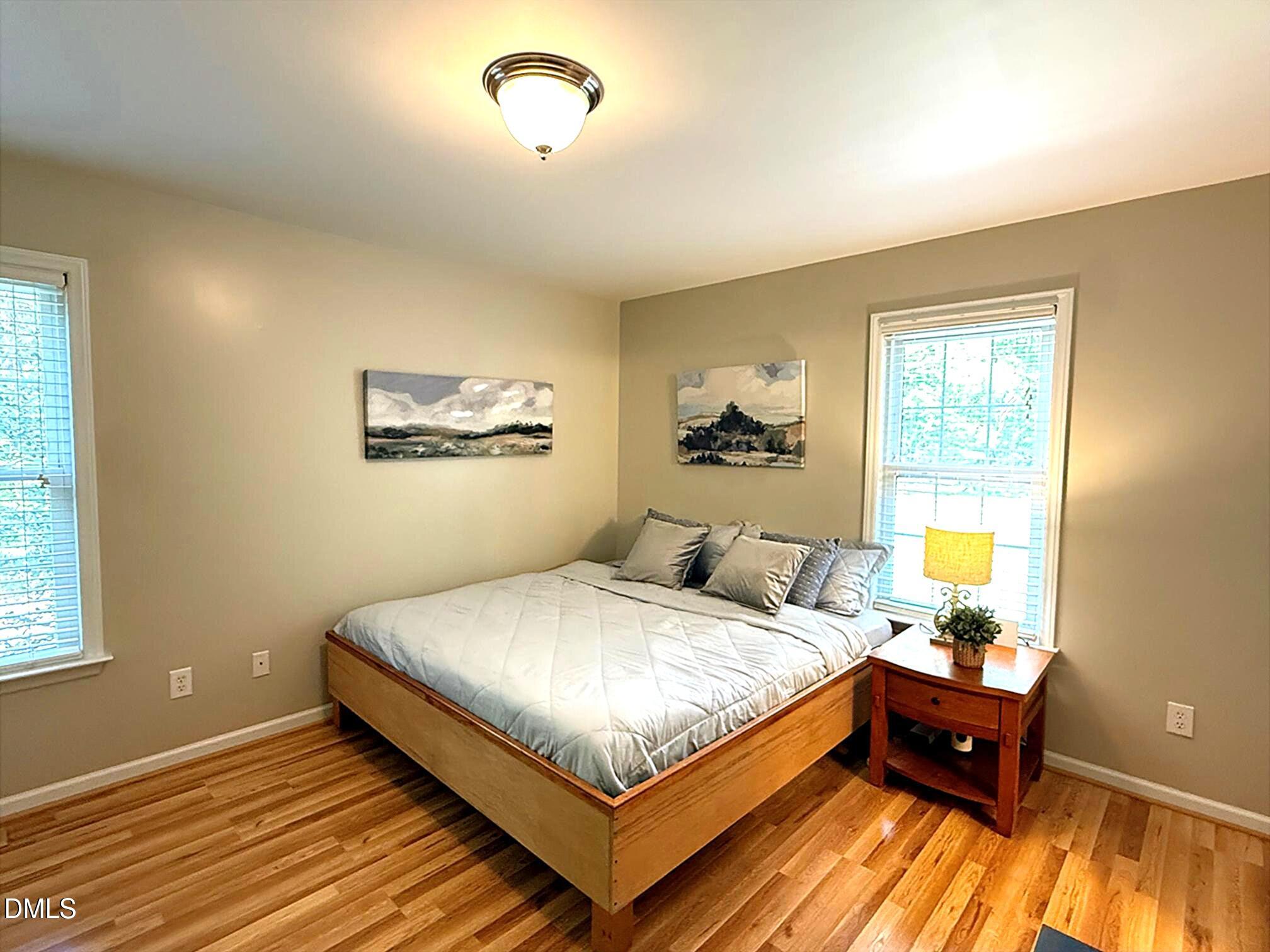 127 Cobble Brook Drive Rougemont, NC 27572 - Photo 17 of 48 a bedroom with a bed and wooden floor