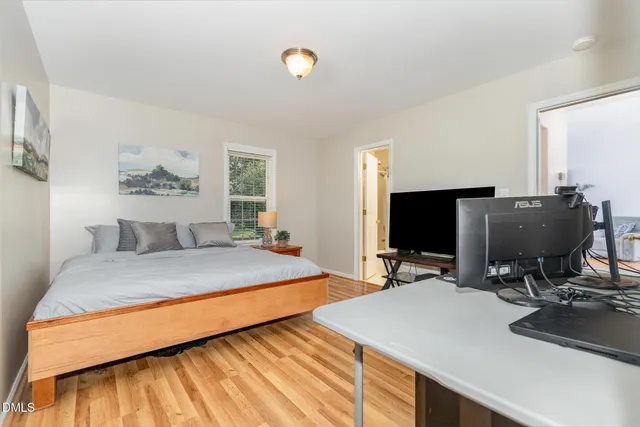 a bedroom with a bed and a flat screen tv