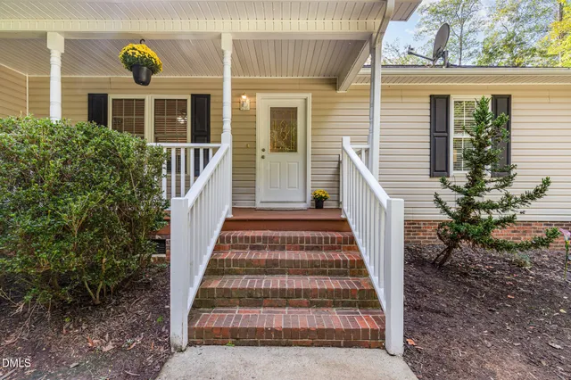 a view of a porch with wooden floor and stairs