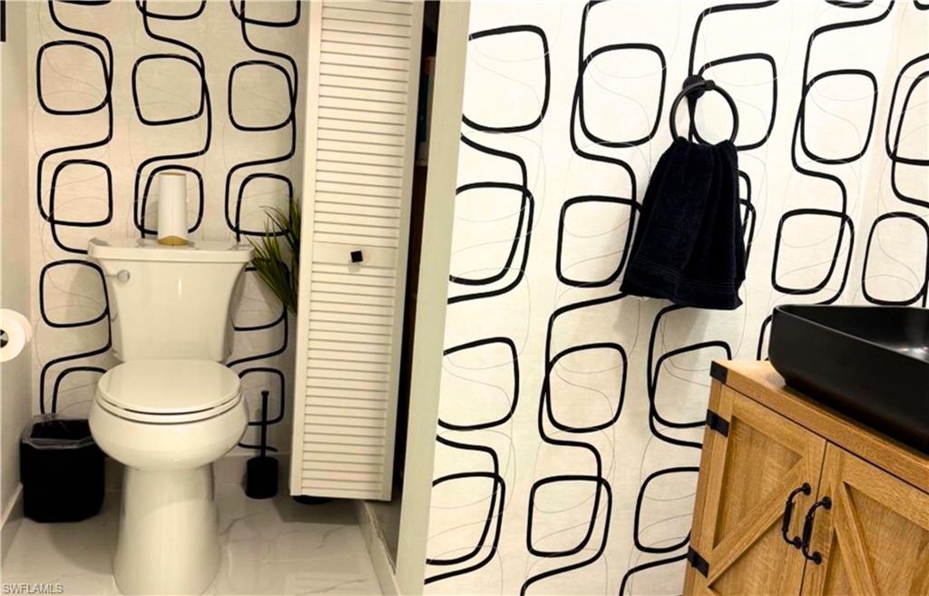 14122 Southwest 276th Street Homestead, FL 33032 - Photo 16 of 47 Bathroom with vanity, a closet, and light marble finish floors