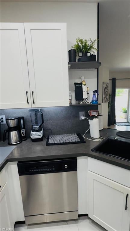 14122 Southwest 276th Street Homestead, FL 33032 - Photo 20 of 47 Kitchen featuring white cabinetry, dark countertops, open shelves, and stainless steel dishwasher