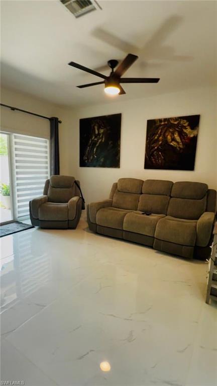 14122 Southwest 276th Street Homestead, FL 33032 - Photo 24 of 47 Living area featuring marble look tiles and a ceiling fan