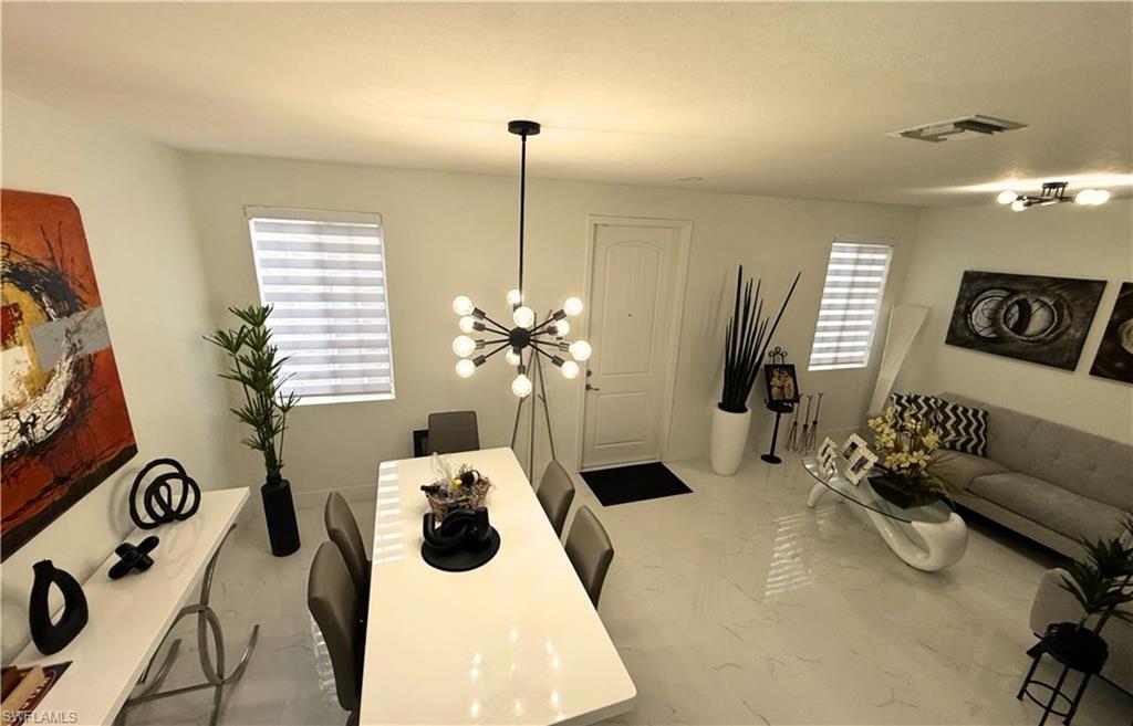14122 Southwest 276th Street Homestead, FL 33032 - Photo 4 of 47 Dining room featuring a chandelier and light marble finish floors