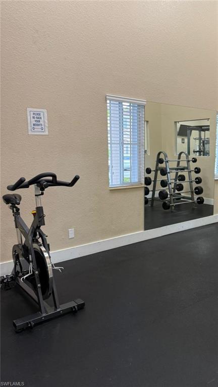 14122 Southwest 276th Street Homestead, FL 33032 - Photo 42 of 47 Gym featuring a textured wall and a textured ceiling