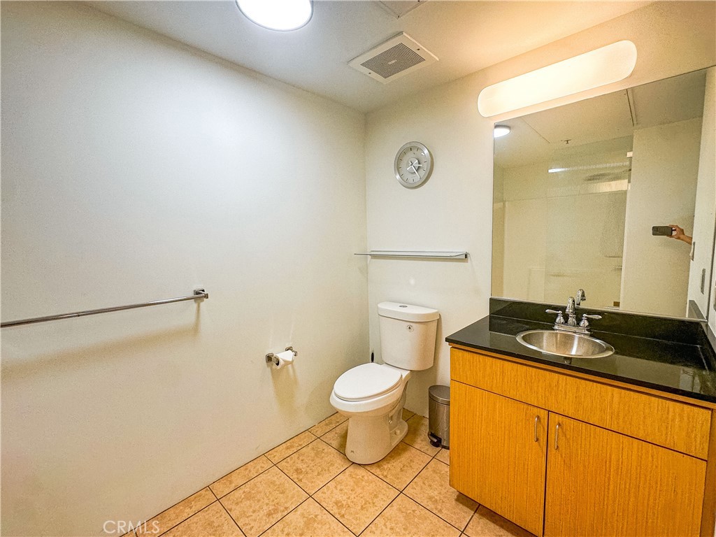 200 North San Fernando Road, Unit 313 Los Angeles, CA 90031 - Photo 13 of 29 a bathroom with a granite countertop sink and a toilet