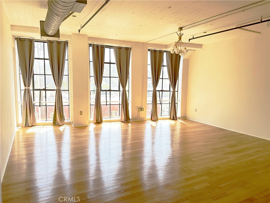 200 North San Fernando Road, Unit 313 Los Angeles, CA 90031 - Photo 2 of 29 a view of an empty room with wooden floor and a window