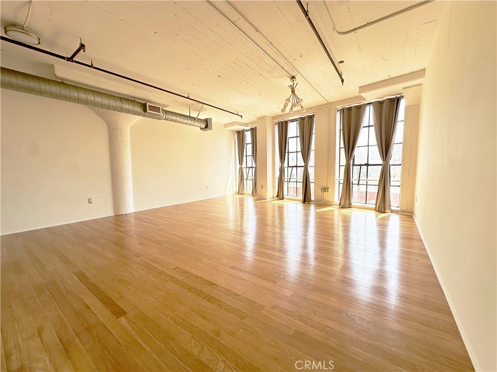 200 North San Fernando Road, Unit 313 Los Angeles, CA 90031 - Photo 3 of 29 a view of an empty room with wooden floor and a window