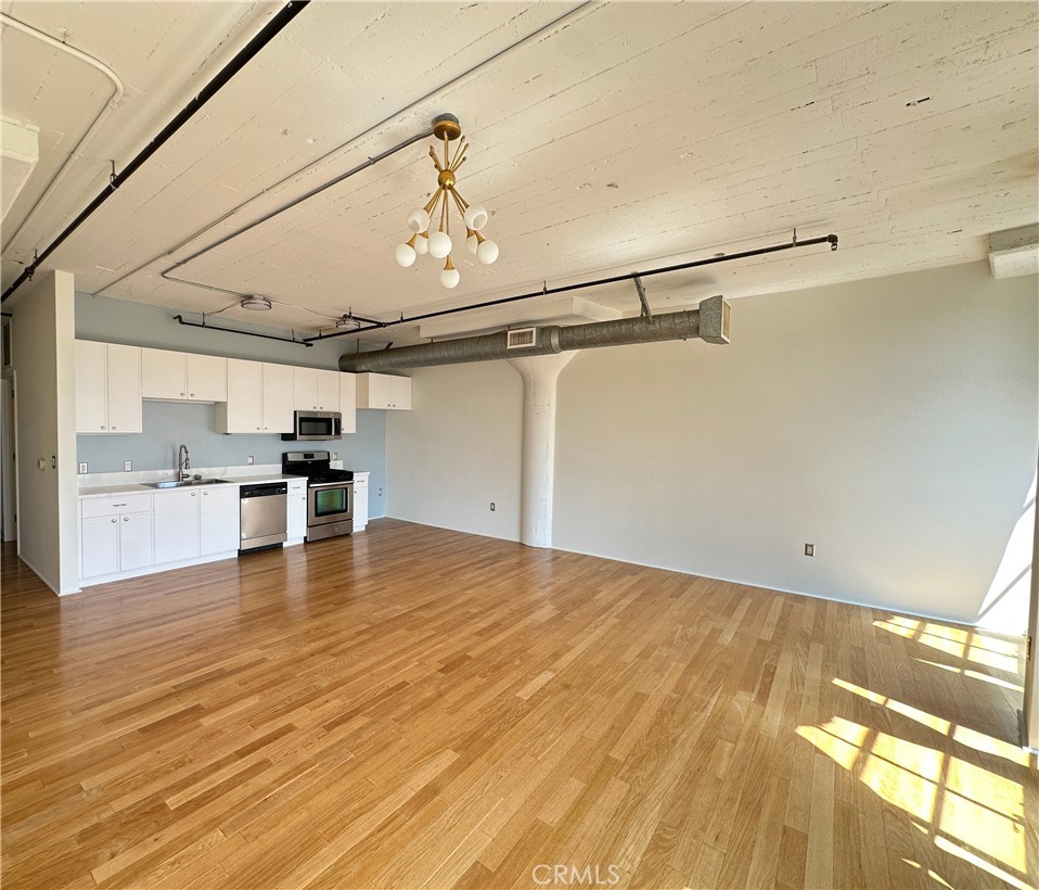 200 North San Fernando Road, Unit 313 Los Angeles, CA 90031 - Photo 6 of 29 a view of a kitchen with a sink and wooden floor
