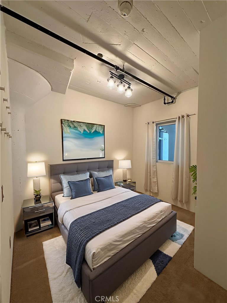 200 North San Fernando Road, Unit 313 Los Angeles, CA 90031 - Photo 7 of 29 a bedroom with a large bed and a chandelier