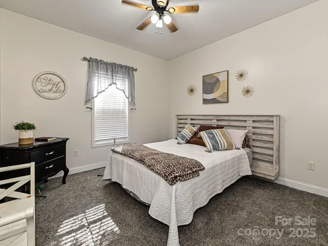 a bedroom with a bed and dresser with mirror