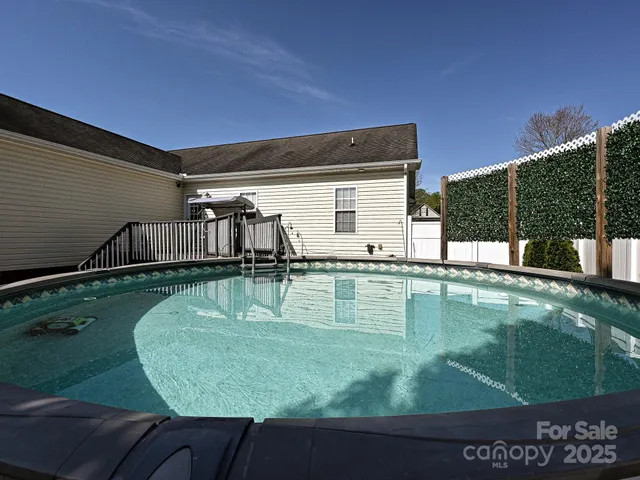 a swimming pool with some trees in the background