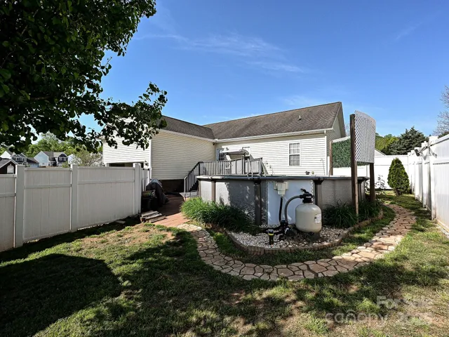 a view of a backyard with plants and a patio