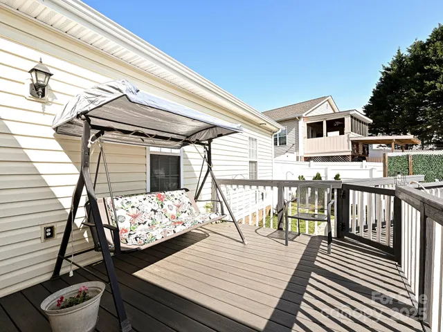 a view of a balcony with wooden floor and seating space