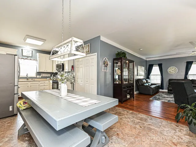 a living room with furniture a dining table and chairs