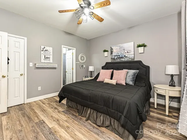 a bedroom with a bed and wooden floor