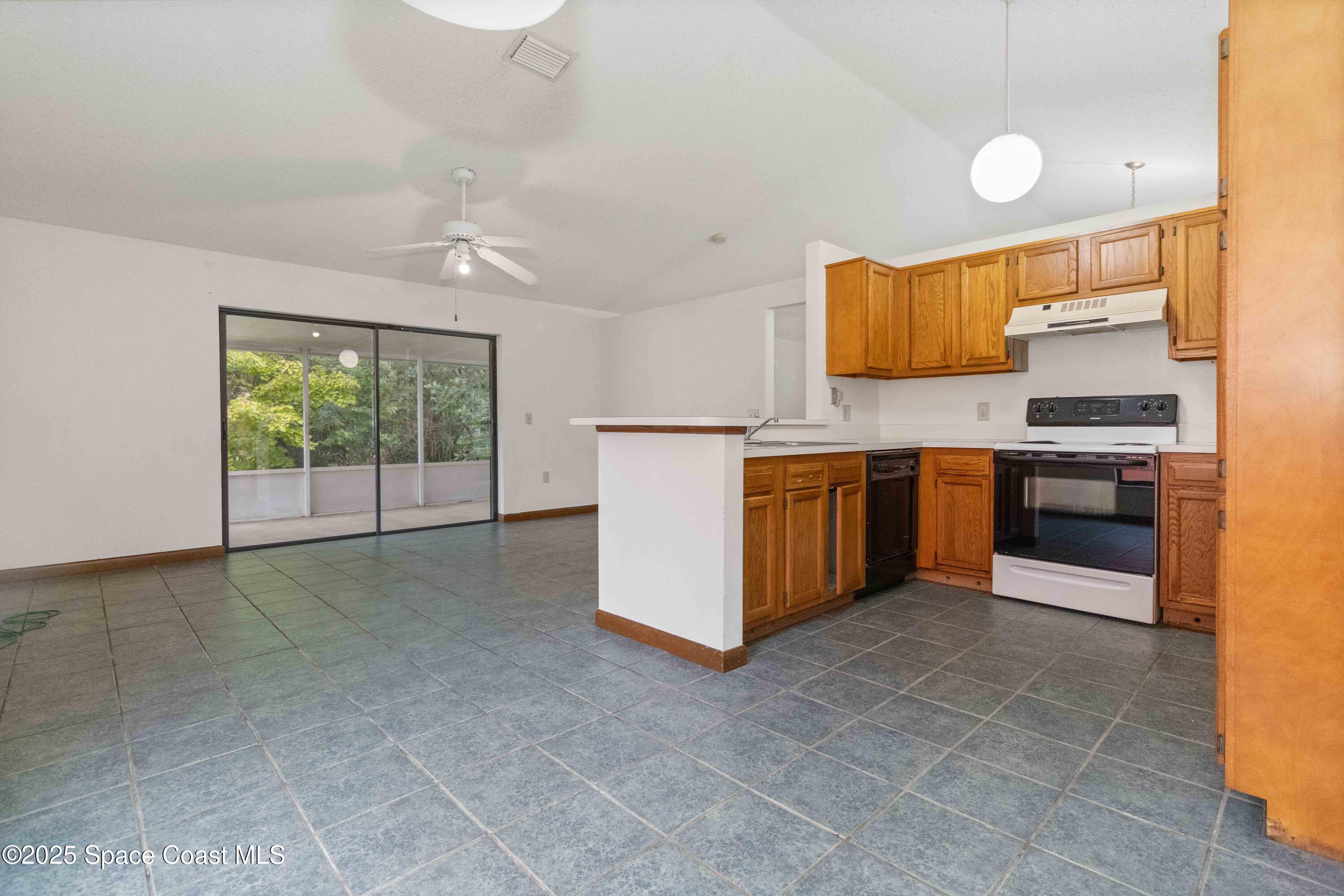 1873 Longleaf Road Cocoa, FL 32926 - Photo 11 of 30 a kitchen with stainless steel appliances granite countertop a stove top oven sink and cabinets