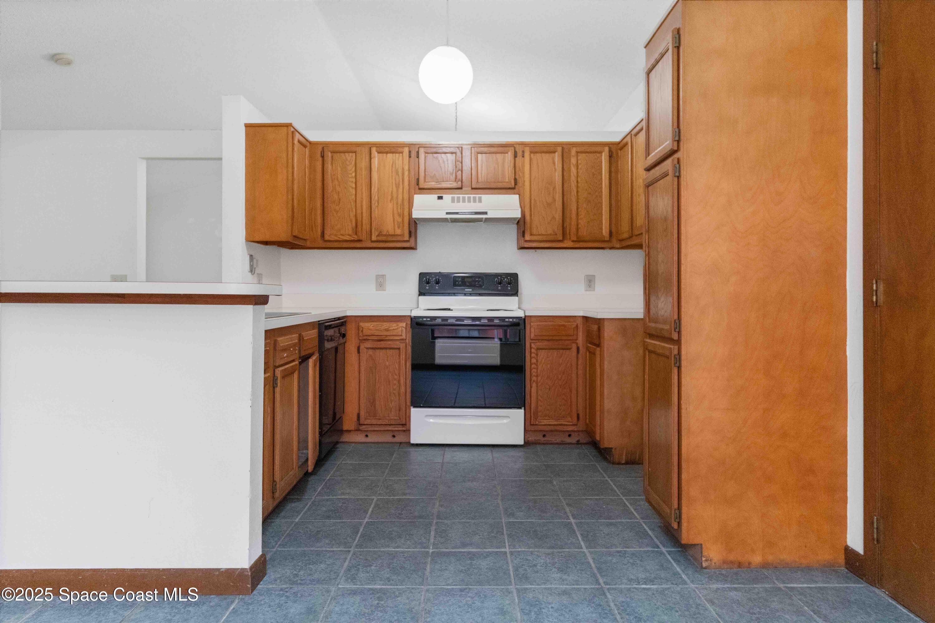 1873 Longleaf Road Cocoa, FL 32926 - Photo 12 of 30 a kitchen with granite countertop a stove and a refrigerator