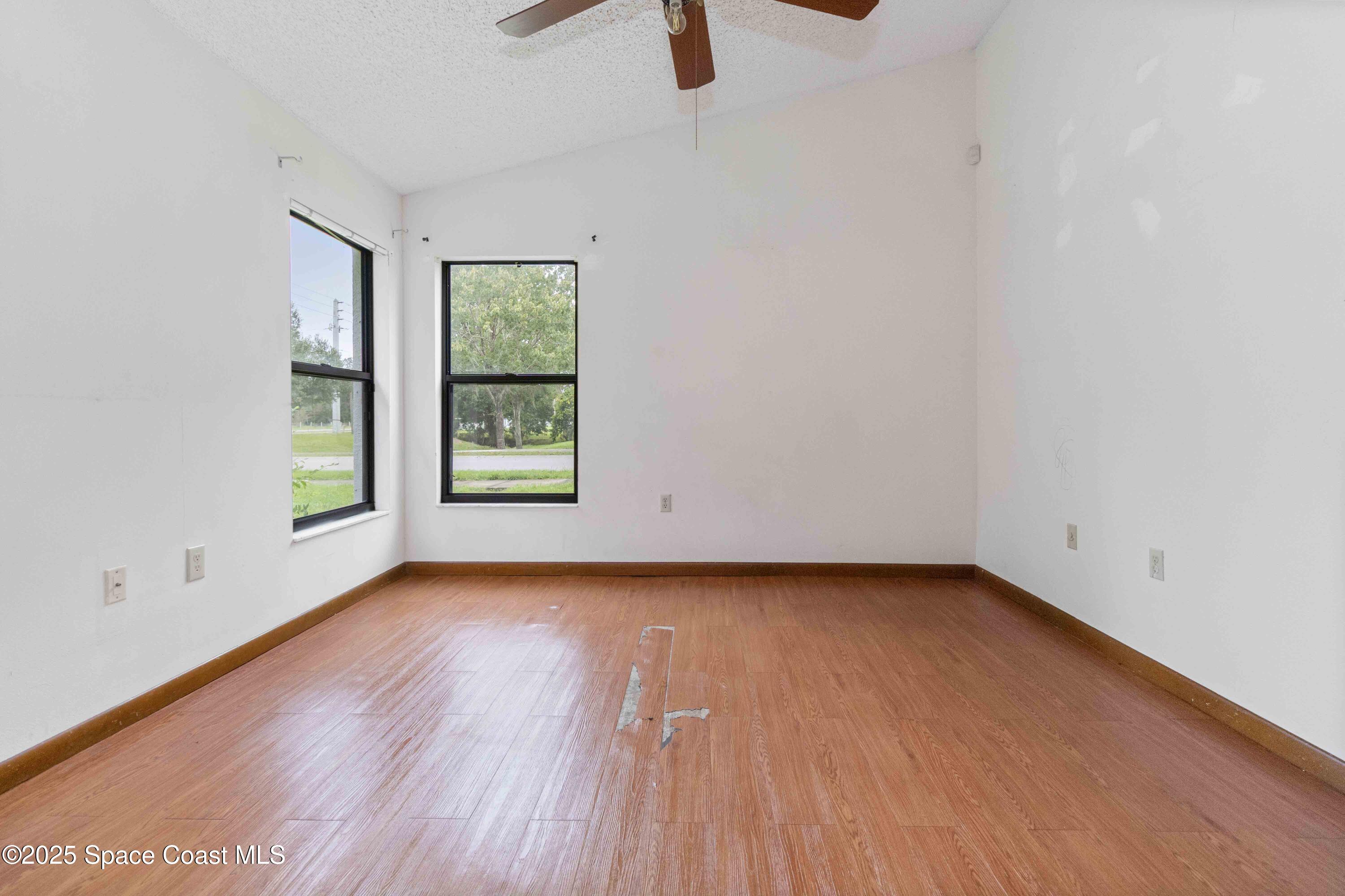 1873 Longleaf Road Cocoa, FL 32926 - Photo 15 of 30 a view of an empty room with window and wooden floor