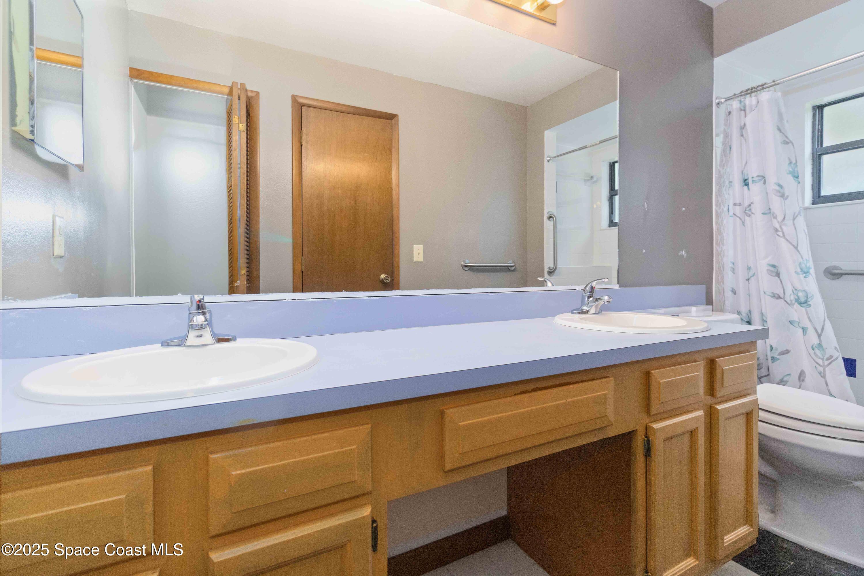 1873 Longleaf Road Cocoa, FL 32926 - Photo 18 of 30 a bathroom with a sink and a mirror