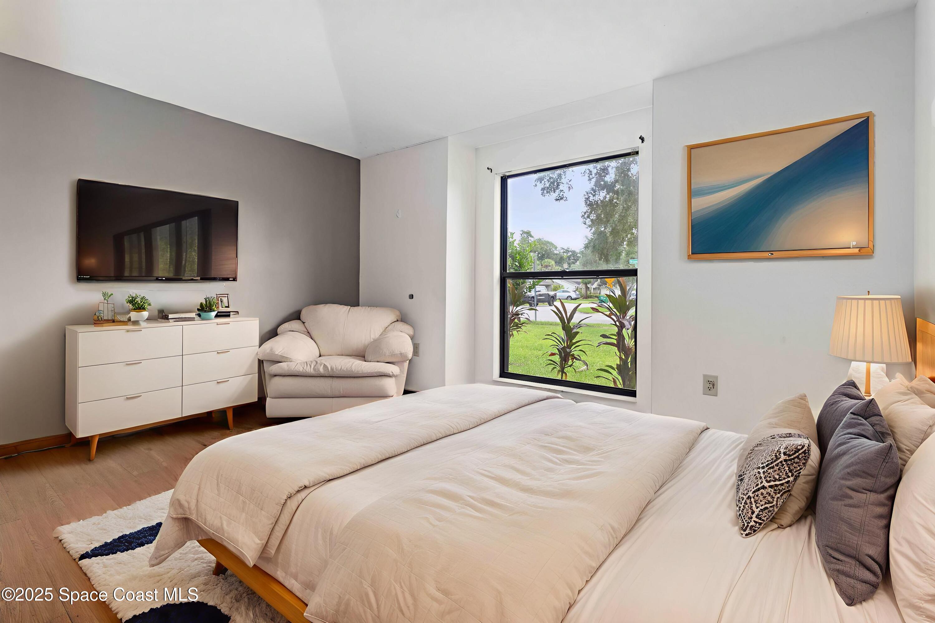 1873 Longleaf Road Cocoa, FL 32926 - Photo 24 of 30 a bedroom with a bed and a flat screen tv