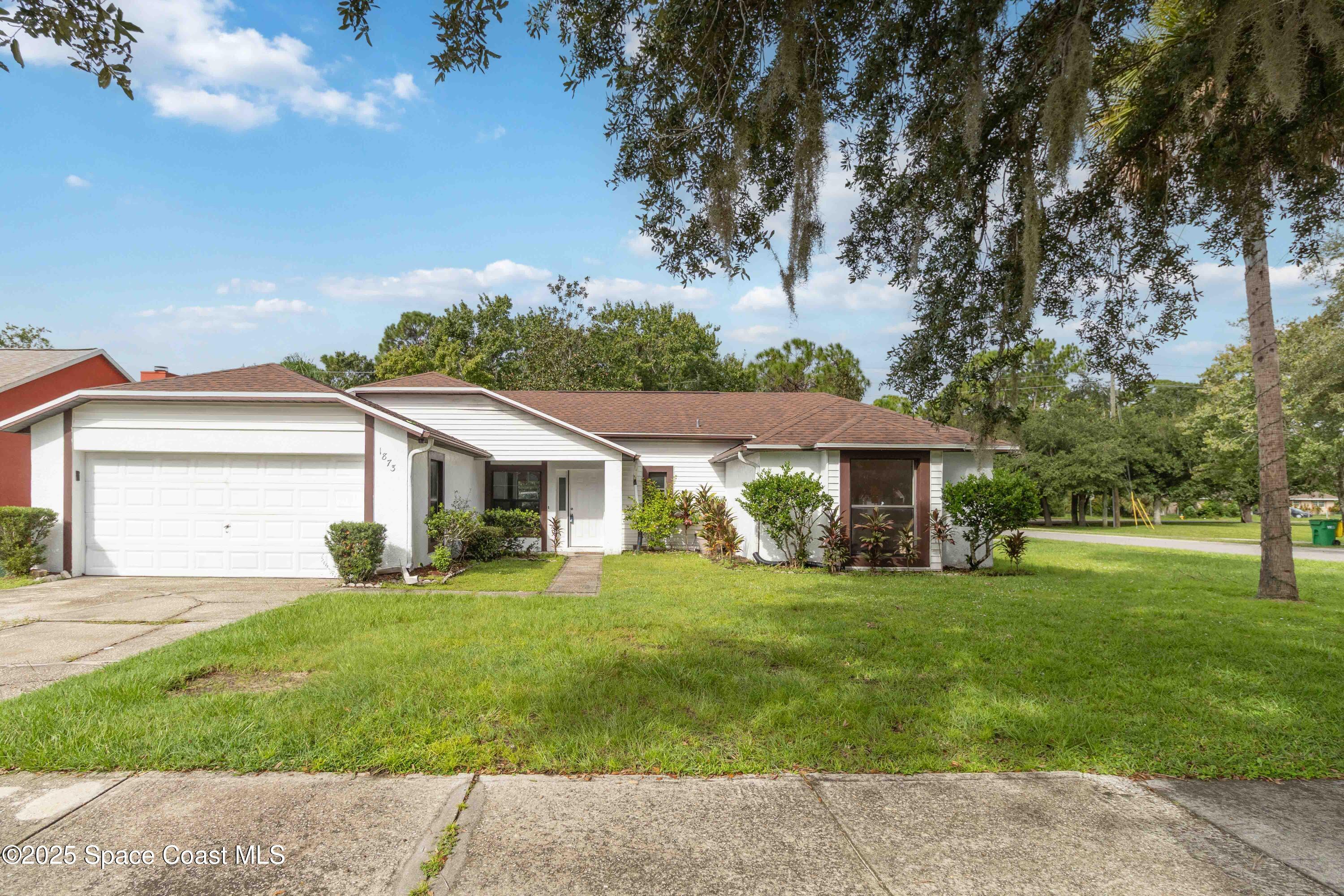 1873 Longleaf Road Cocoa, FL 32926 - Photo 30 of 30 a view of a house with a big yard and large trees