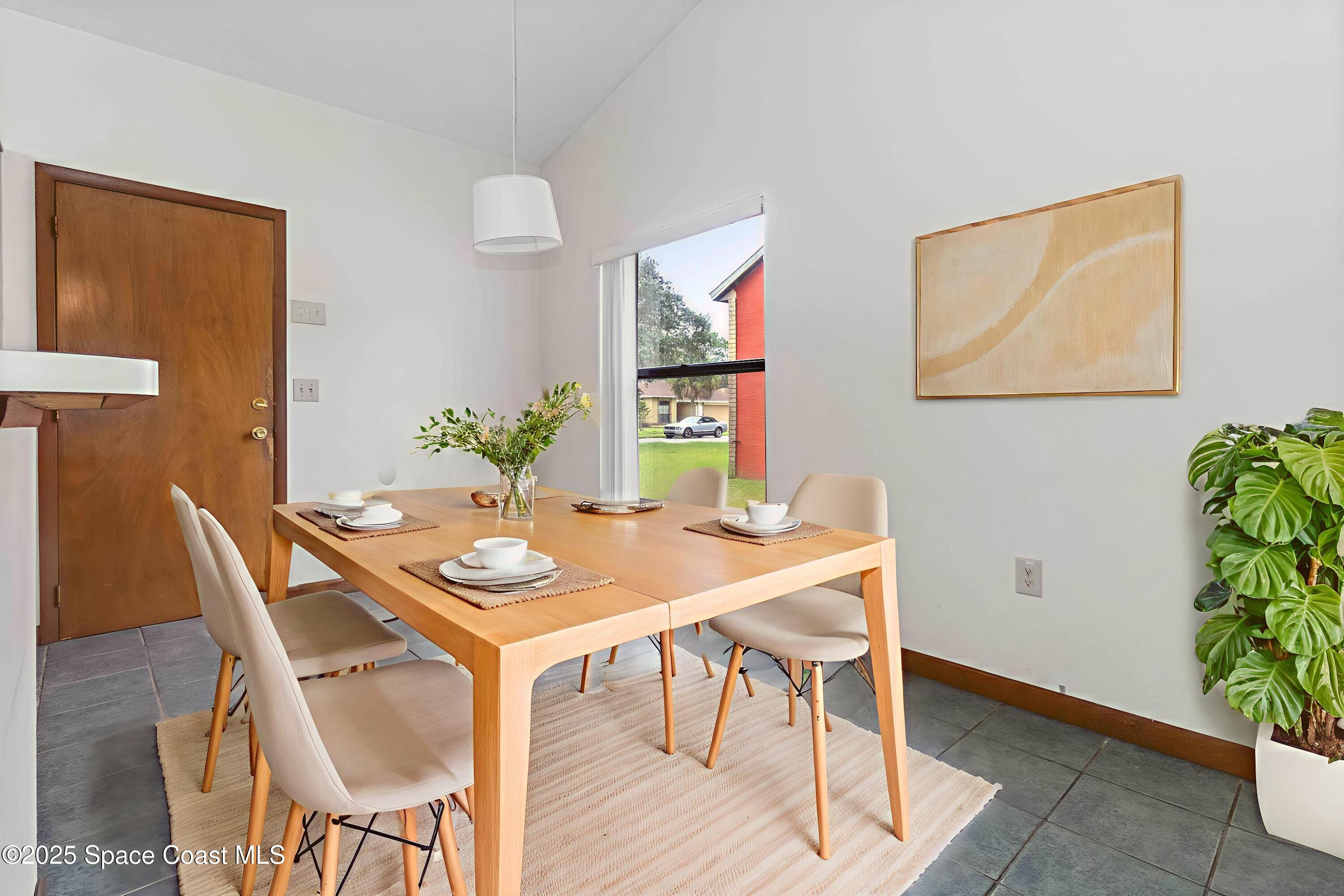 1873 Longleaf Road Cocoa, FL 32926 - Photo 10 of 30 a view of a dining room with furniture and wooden floor