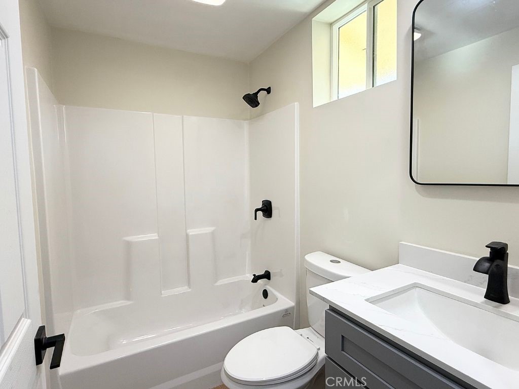 13938 Ragus Street La Puente, CA 91746 - Photo 5 of 6 a bathroom with a granite countertop sink toilet and shower