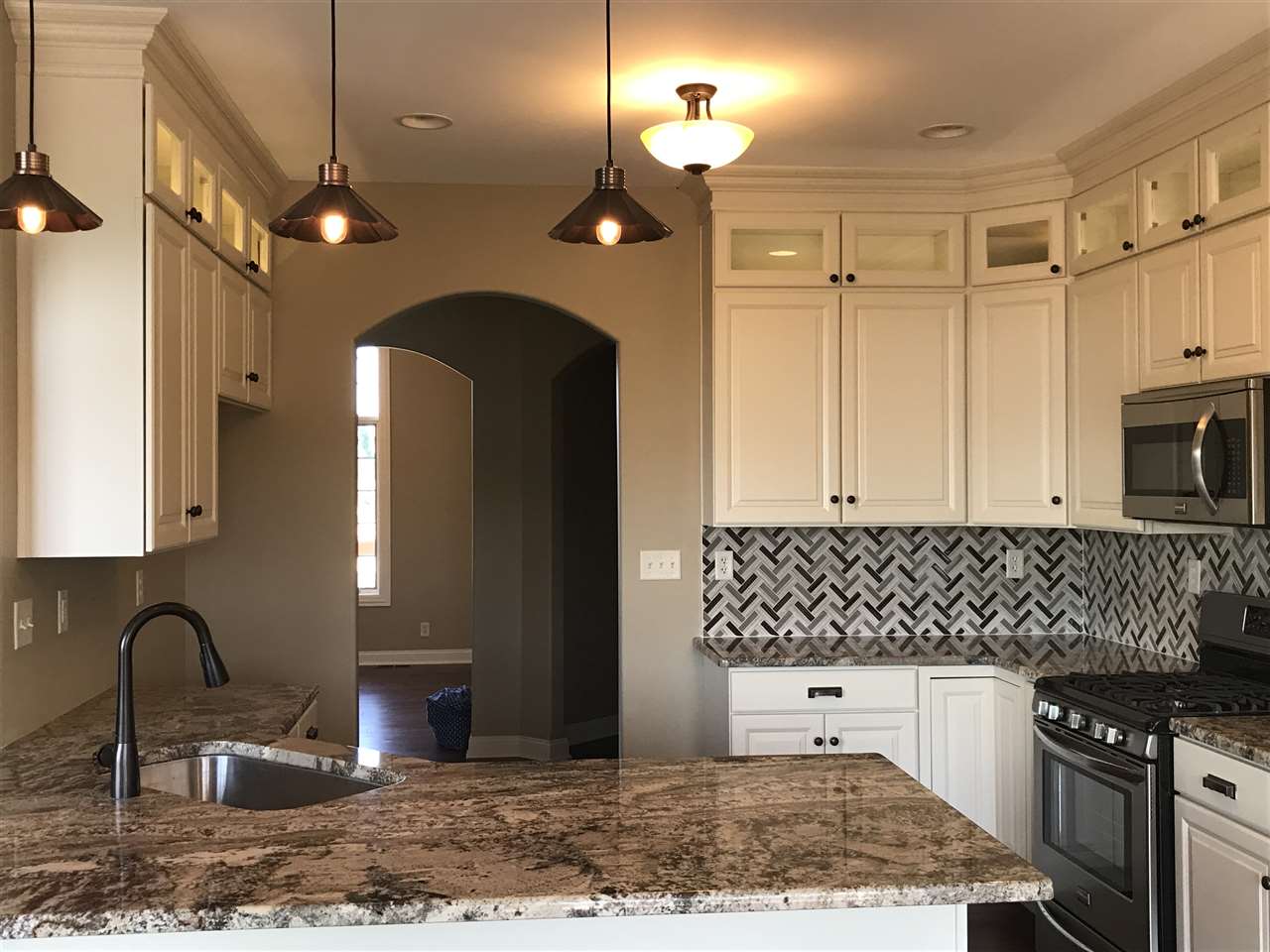 2840 Hamson Way Belvidere, IL 61008 - Photo 3 of 24 a kitchen with stainless steel appliances granite countertop a sink stove and refrigerator