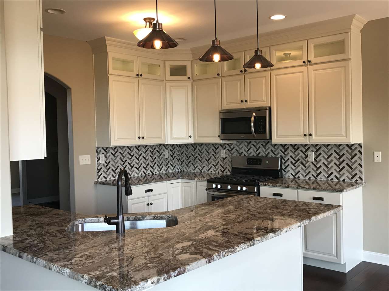 2840 Hamson Way Belvidere, IL 61008 - Photo 4 of 24 a kitchen with granite countertop a sink a stove and cabinets