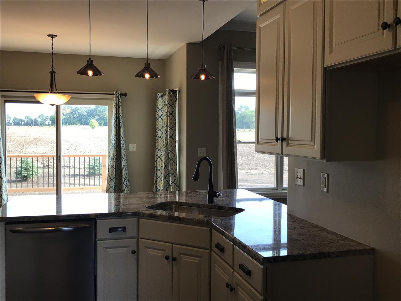 2840 Hamson Way Belvidere, IL 61008 - Photo 6 of 24 a kitchen with kitchen island granite countertop a sink stainless steel appliances cabinets and a counter top space