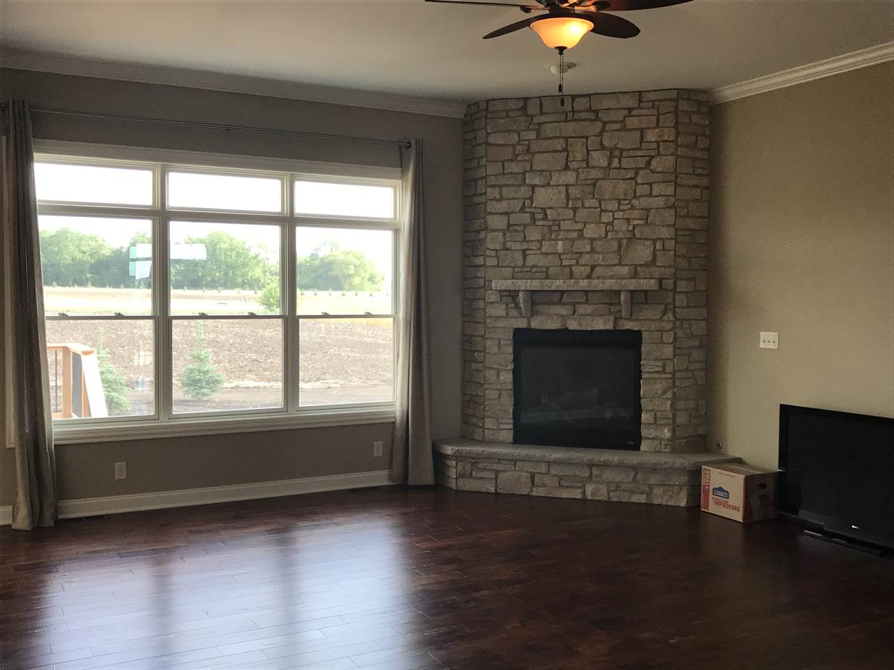 2840 Hamson Way Belvidere, IL 61008 - Photo 8 of 24 a living room with a fireplace and a ceiling fan